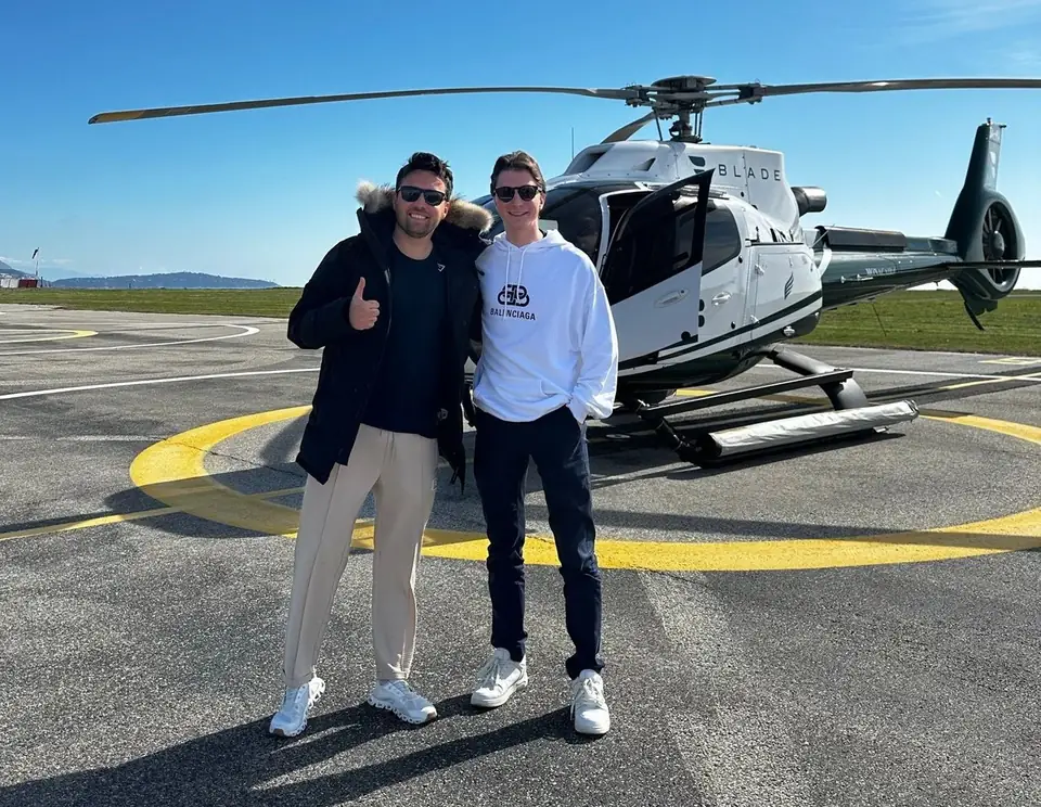 Markus and a friend in front of a helicopter