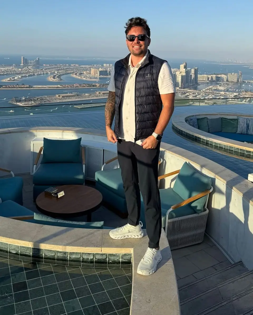 Markus Behmann on a rooftop terrace in Dubai, the Palm in the background